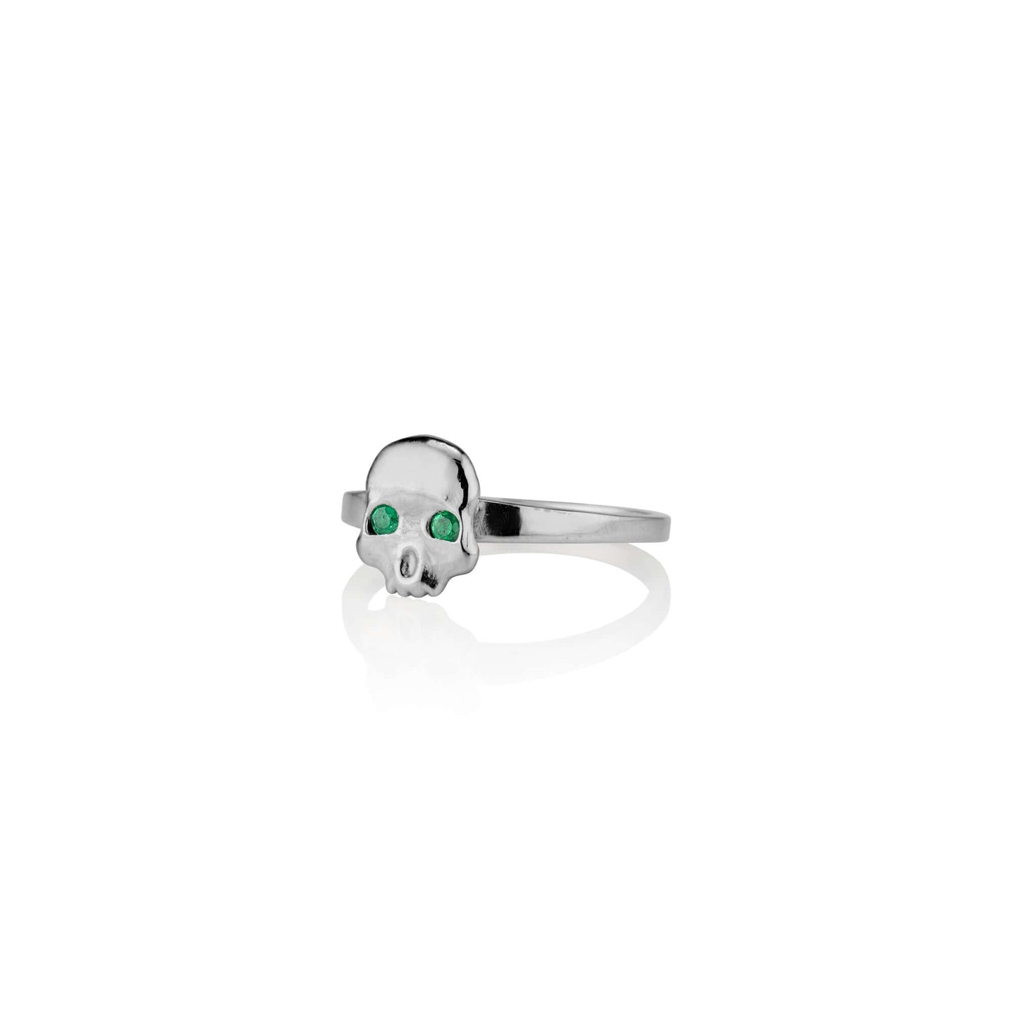 Platinum and Emerald Ossification RingA little skull ring for every day wear. We wanted to design a fun and simple skull ring that adds the perfect amount of goth and that could stack well with other rings. We're so excited to now offer this piece in shin