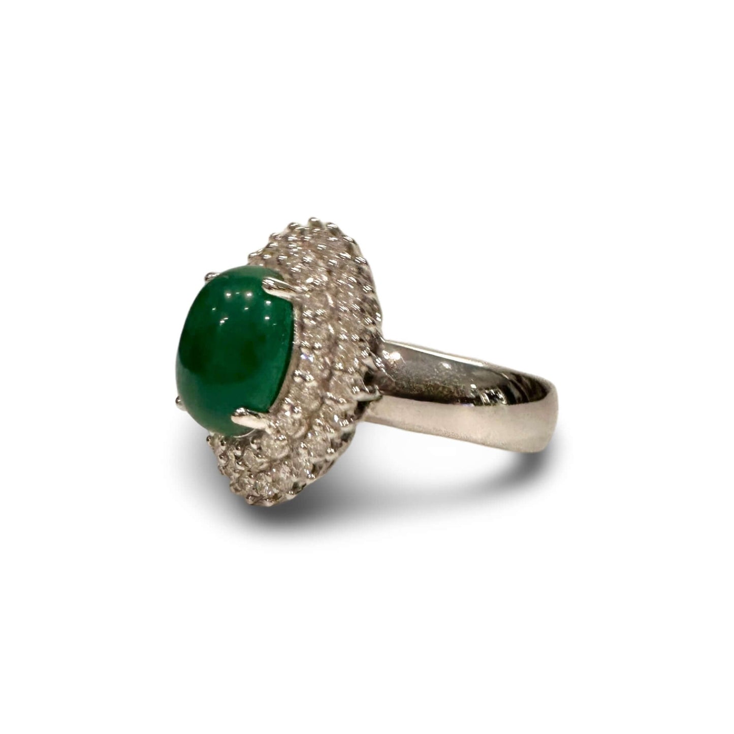 Vintage Diamond and Jade Ring in 14k White GoldGorgeous Jade Cabochon set in a halo of white diamonds. TCW of the diamonds is 0.75cts. Ring is 14k White Gold Condition: Normal antique wear Metal: 14k White Gold Dimensions: Size 6Vintage Diamond and Jade R