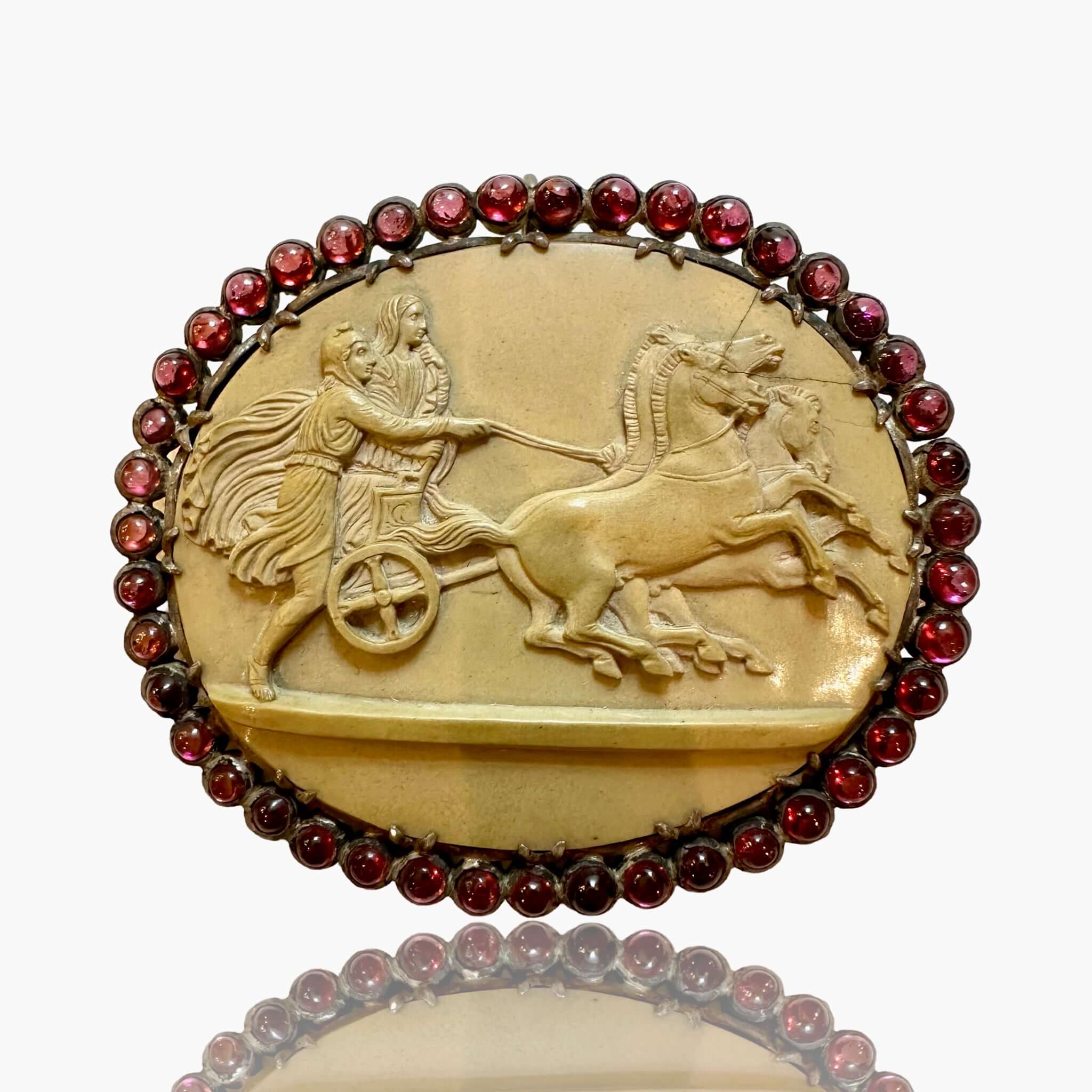 Antique Victorian Lava Cameo Brooch, Garnet Surround, 1860sAntique Victorian Lava Cameo Brooch, Garnet Surround, 1860s, Roman Chariot Condition: Normal antique wear Metal: Silver Dimensions: 2.75", 32.1g Antique Victorian Lava Cameo Brooch, Garnet Surroun