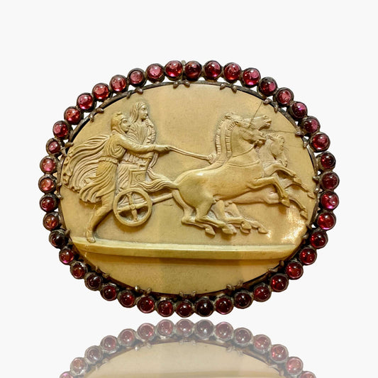 Antique Victorian Lava Cameo Brooch, Garnet Surround, 1860sAntique Victorian Lava Cameo Brooch, Garnet Surround, 1860s, Roman Chariot Condition: Normal antique wear Metal: Silver Dimensions: 2.75", 32.1g Antique Victorian Lava Cameo Brooch, Garnet Surroun