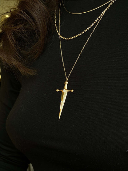 18k Gold Kelly Sword PendantA Luxe sword 18k Gold Kelly Sword Pendant for the individual wanting to make a powerful statement. Our Jewelry is proudly idealized, and produced in NYC.18k Gold Kelly Sword PendantA Luxe sword pendant for the individual wantin