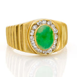 Vintage 18k Yellow Gold Jade and Diamond Ringcentering an oval jadeite cabochon of bright apple green color, surrounded by diamonds with ribbed shoulders. Can be resized. Condition: Normal antique wear Metal: 18k Yellow Gold Dimensions: Size 8Vintage 18k