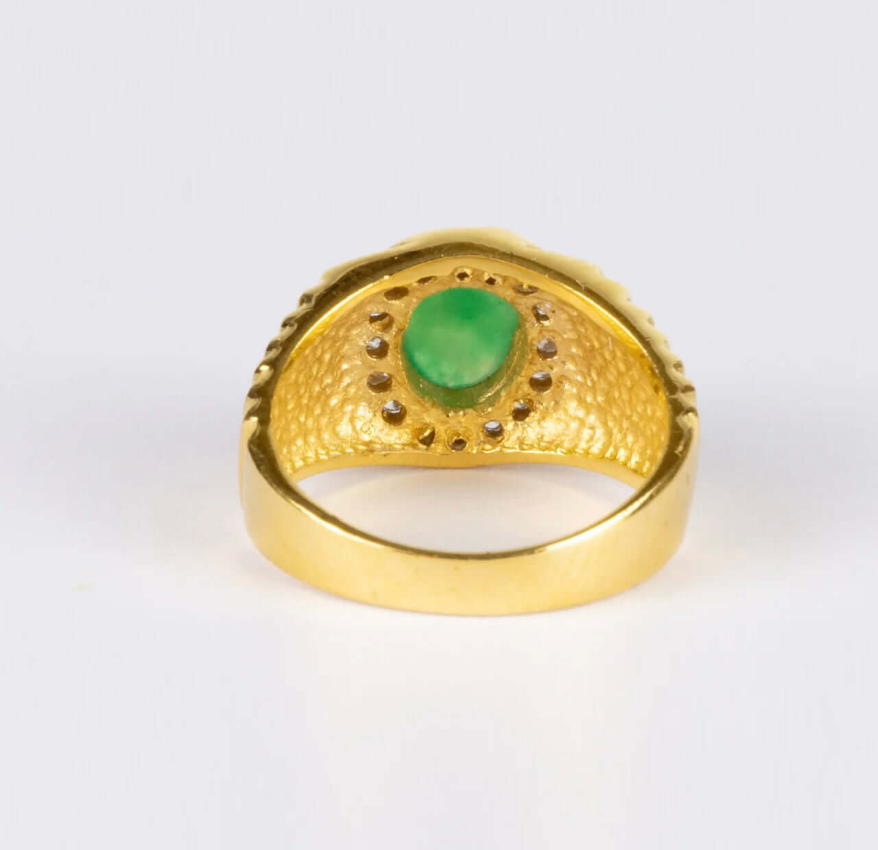 Vintage 18k Yellow Gold Jade and Diamond Ringcentering an oval jadeite cabochon of bright apple green color, surrounded by diamonds with ribbed shoulders. Can be resized. Condition: Normal antique wear Metal: 18k Yellow Gold Dimensions: Size 8Vintage 18k