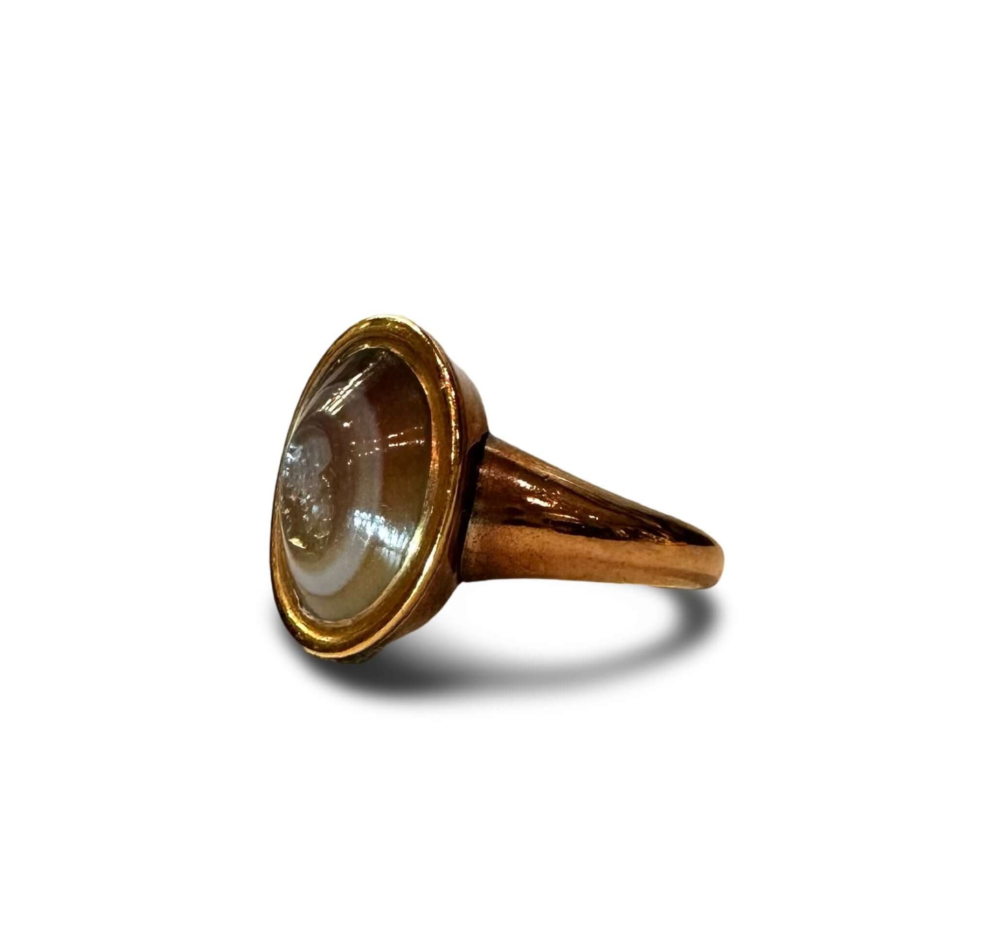 ROMAN INTAGLIO RING BANDED AGATEThe Oval stone engraved with the portrait head of a philosopher, perhaps Socrates, with a bald plate, long hair at the side, a pug nose and a full beard. Mounted as a ring, 19th century gold setting. • Roman Empire; 1st Cen