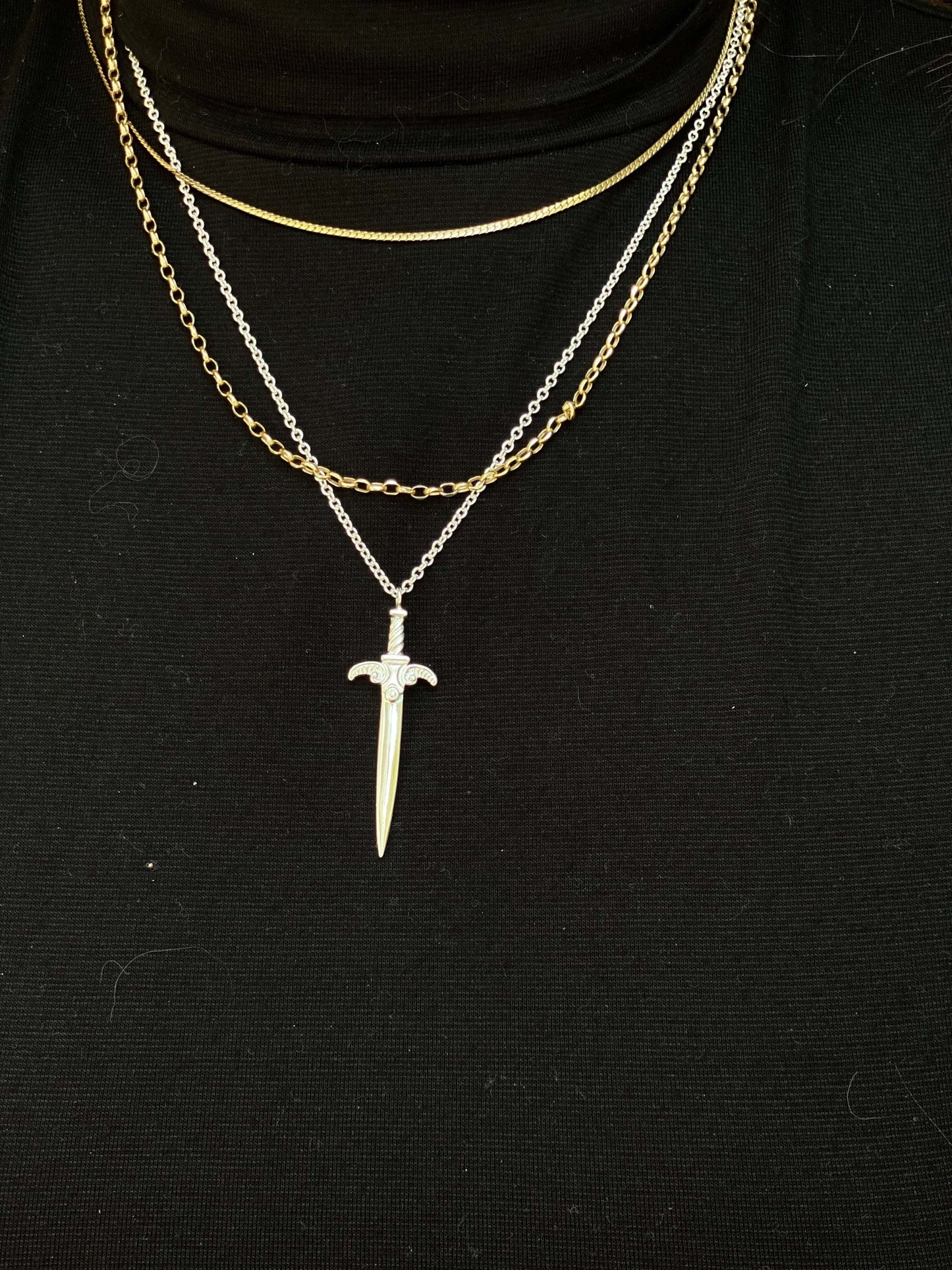 Agape Sword PendantA more romantic and whimsical take on our Kelly Sword pendant. Inspired by the more organic motifs from our Teras Collection, we decided to create a second sword pendant for our collection that was a bit more detailed while still being