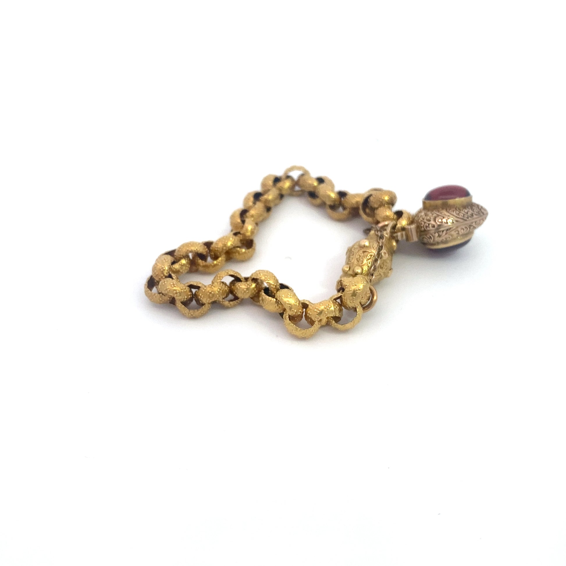 Georgian Era Gold Link Bracelet with Foiled Garnet PadlockMeasuring 7 inches in length, this elegant bracelet features a stunning foiled garnet padlock, showcasing the exceptional craftsmanship of the Georgian period. Likely of English origin, this bracel