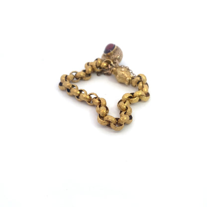 Georgian Era Gold Link Bracelet with Foiled Garnet PadlockMeasuring 7 inches in length, this elegant bracelet features a stunning foiled garnet padlock, showcasing the exceptional craftsmanship of the Georgian period. Likely of English origin, this bracel