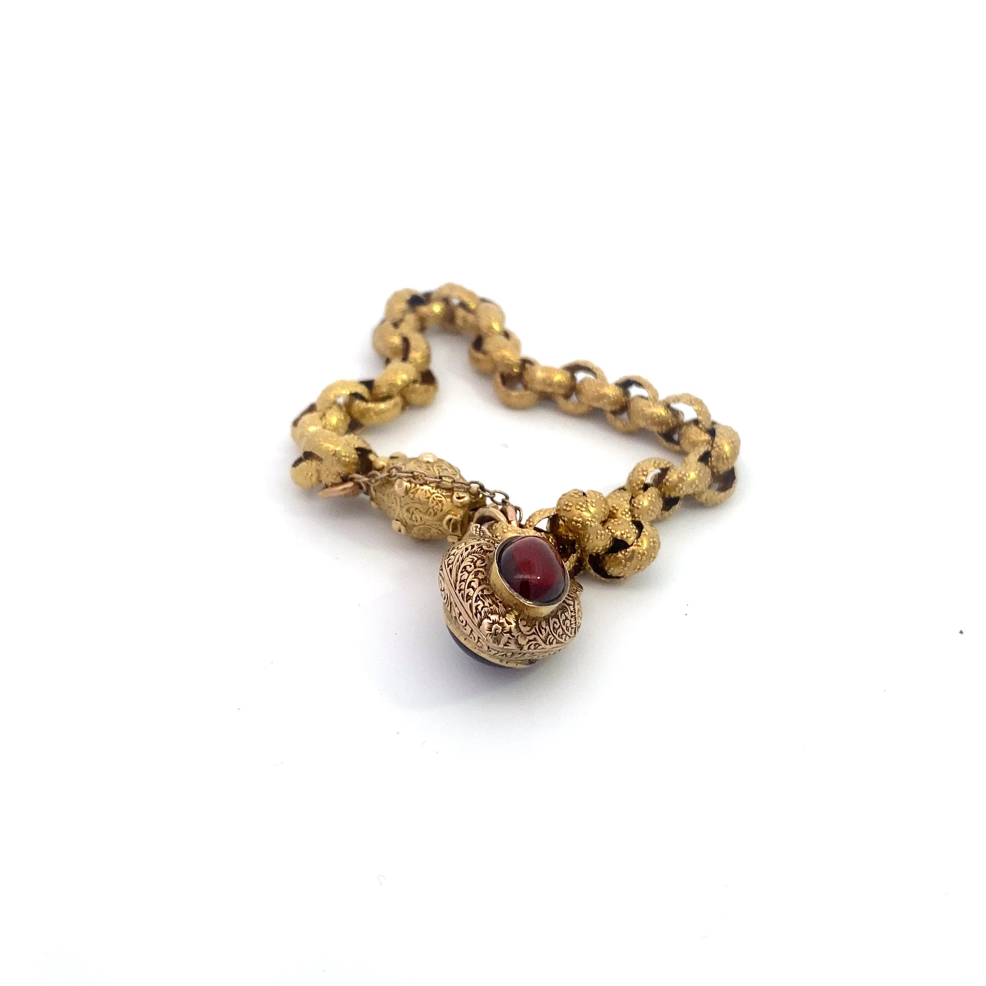 Georgian Era Gold Link Bracelet with Foiled Garnet PadlockMeasuring 7 inches in length, this elegant bracelet features a stunning foiled garnet padlock, showcasing the exceptional craftsmanship of the Georgian period. Likely of English origin, this bracel