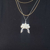 Eye of the Storm PendantInspired by the eye of a hurricane and the gods of wind, this pendant was designed entirely by hand. The pendant comes with an 18” chain. 10% of all sales will be donated to All Hands and Hearts to help them provide aid to communit