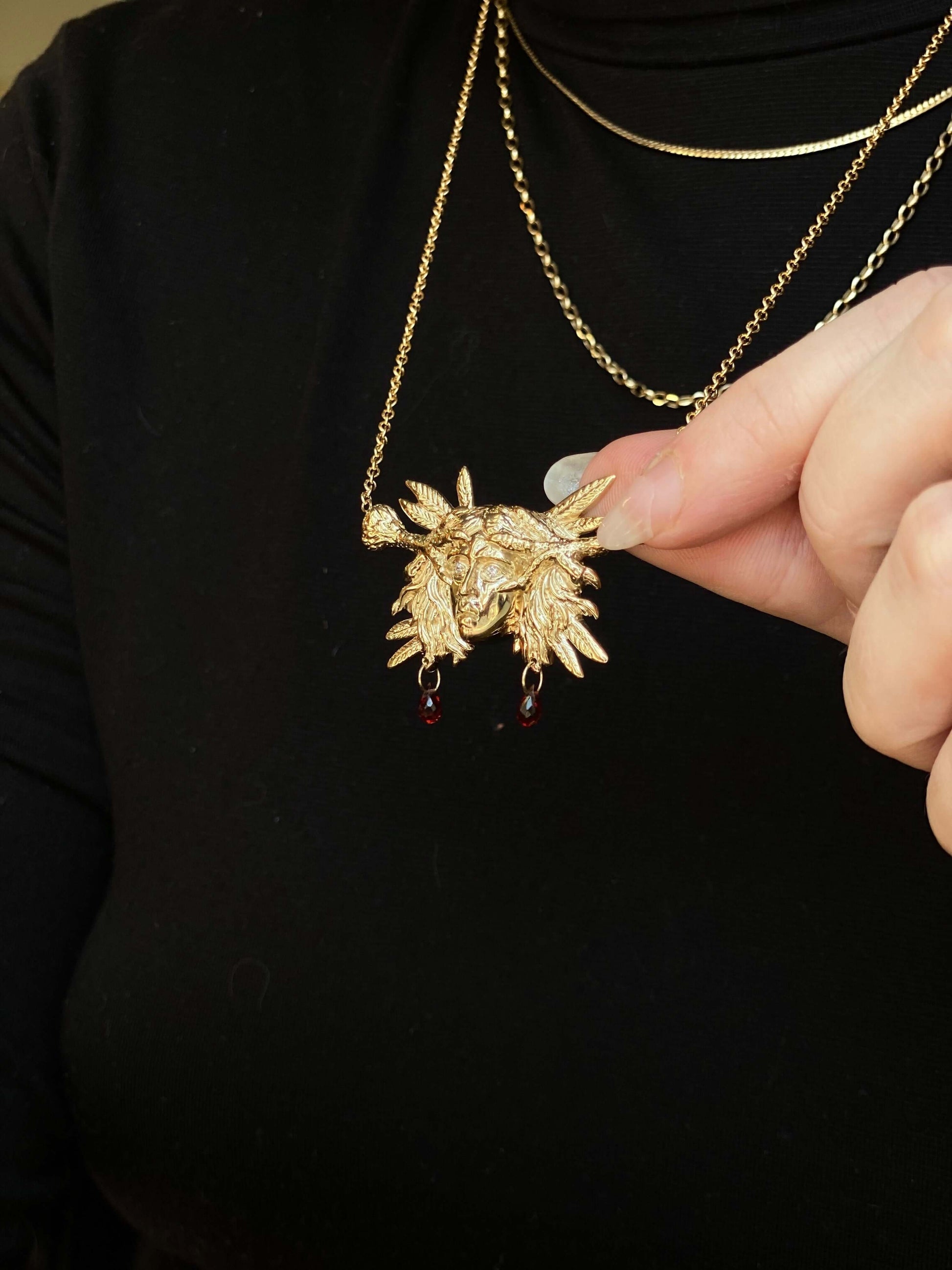 Harpy PendantA sculptural pendant of a woman's head clutched between two bird talons. Harpies were mythological creatures with human and bird like features that stole food and travelers. 10% of each sale will be donated to The American Bird Conservancy (h