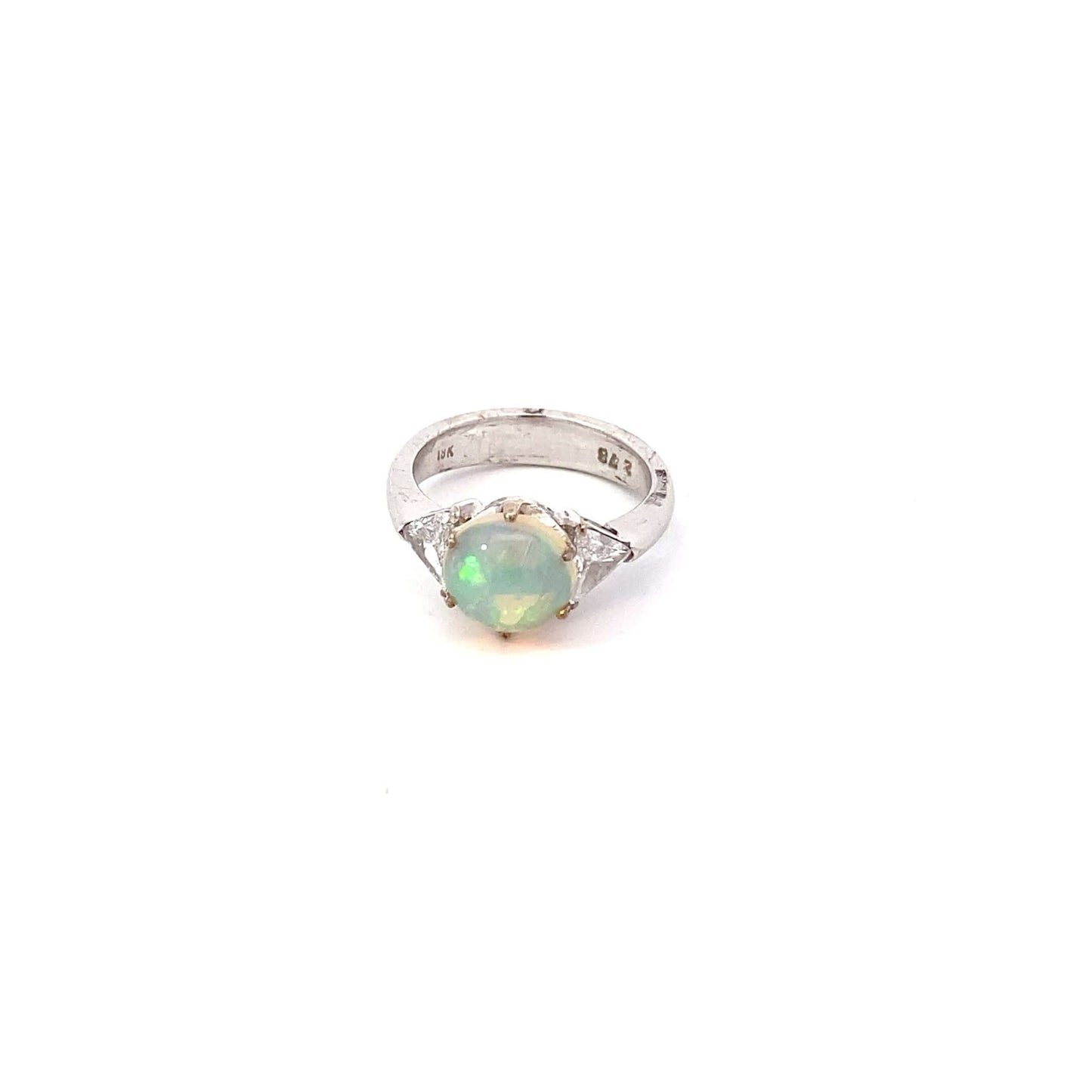 Antique Opal and Trillion Cut Diamond RingDiscover an incredible opal find with this stunning 18k white gold three-stone ring! Featuring a mesmerizing, almost 10mm opal cabochon as its center stone, this ring is a future heirloom in the making. The opal i