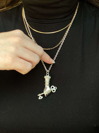 Hekate Dexia - The KeyBased on the traditional Figa the Mano Fico, this pendant is intended to be a symbol to ward of evil and protect the wearer. The inspiration behind it was Hekate, the greek god of witchcraft, the moon, and femininity. In her hands sh