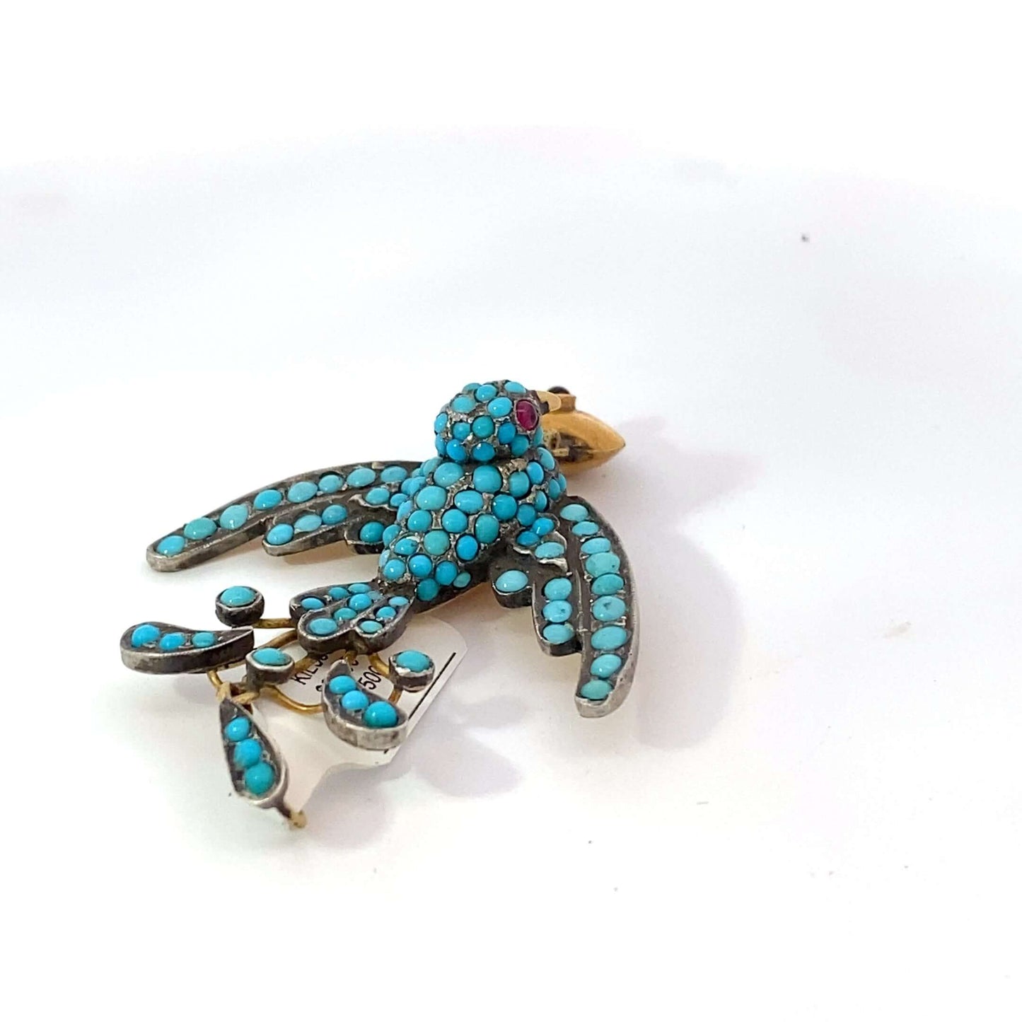 Antique Victorian Bird Pendant, low karat gold, pave turquoise, garnet eyes, hearthis exquisite pendant features a beautifully detailed bird, symbolizing freedom and love, crafted from low karat gold. The bird's body is adorned with pavé turquoise, adding