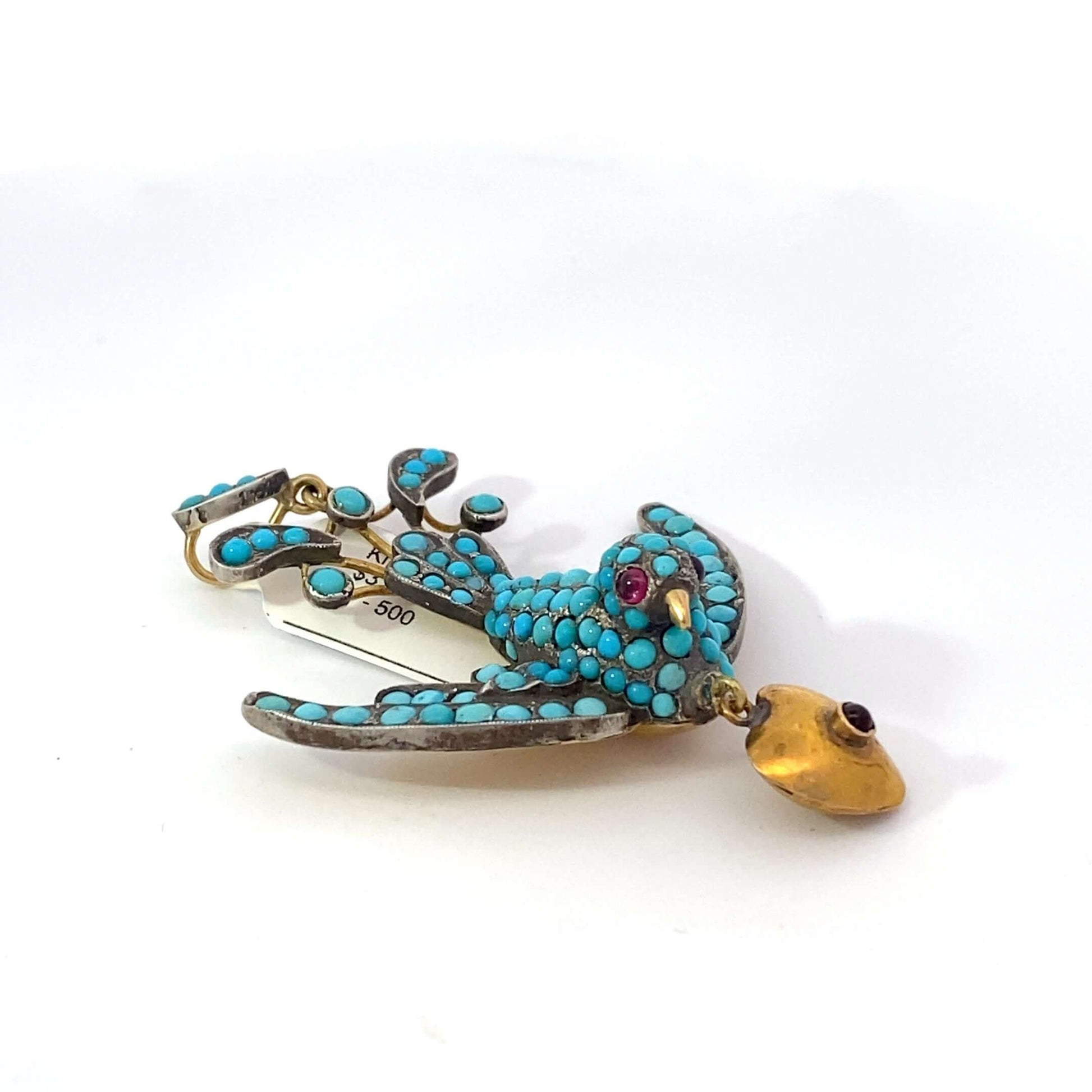 Antique Victorian Bird Pendant, low karat gold, pave turquoise, garnet eyes, hearthis exquisite pendant features a beautifully detailed bird, symbolizing freedom and love, crafted from low karat gold. The bird's body is adorned with pavé turquoise, adding