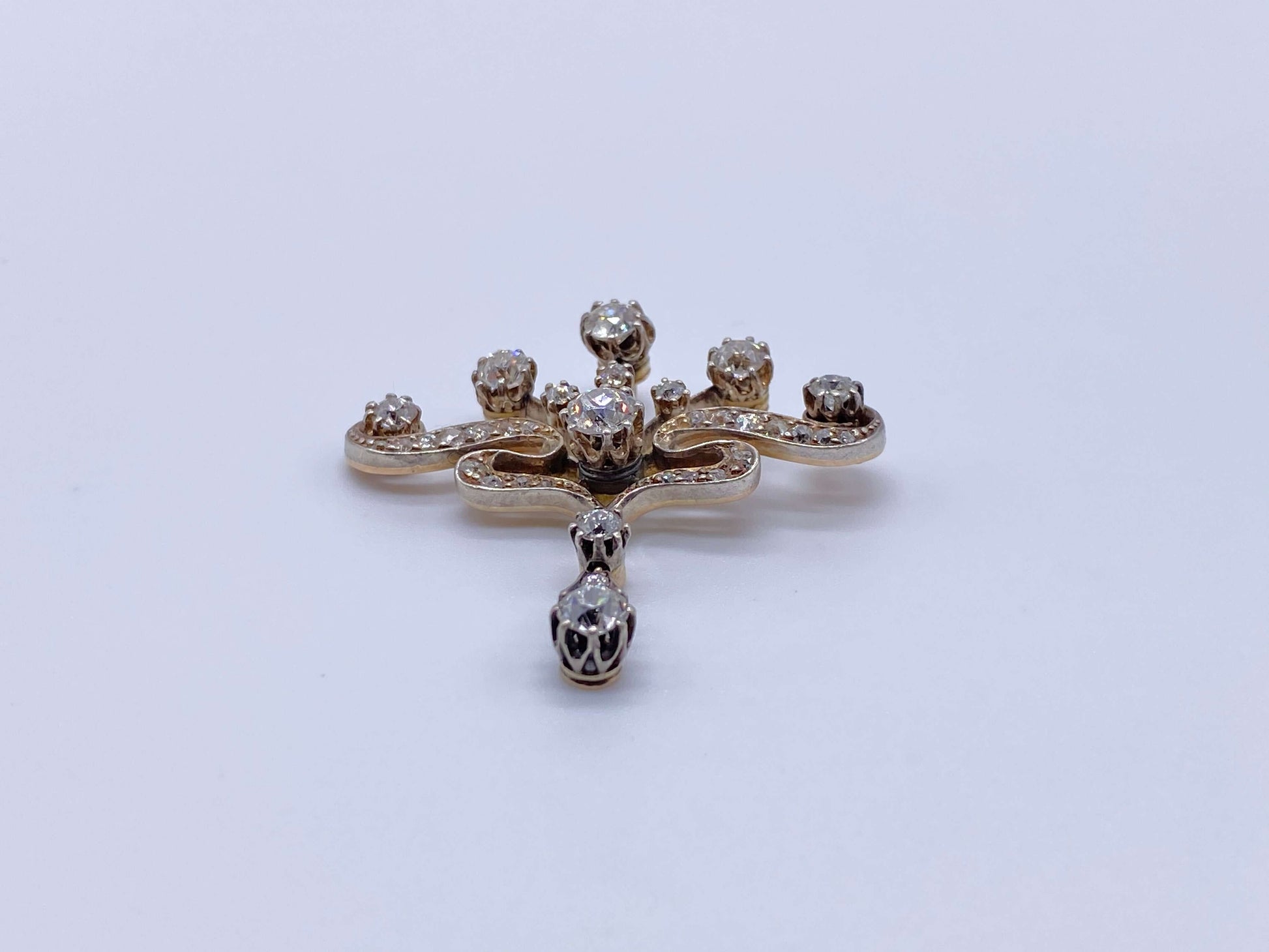 Edwardian Diamond PendantPictures alone cannot capture how beautiful this piece of jewelry is. Beautiful round cut diamonds set with prongs. The bottom diamond is a festoon drop that moves. Would look beautiful worn with a simple white gold chain. Conditi