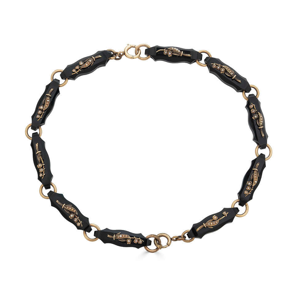 Black Onyx & Gold Lily of the Valley Bracelet SetThis bracelet set is gorgeous and versatile as it can also be worn as a necklace instead of two bracelets. Gorgeous pearls and gold are used to create Lily of the valley flowers on each individual black ony