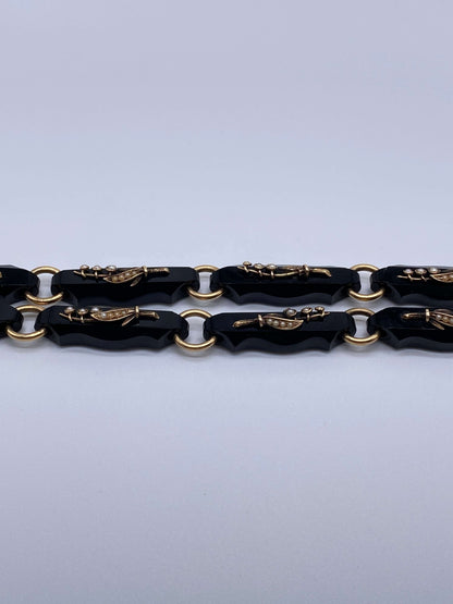 Black Onyx & Gold Lily of the Valley Bracelet SetThis bracelet set is gorgeous and versatile as it can also be worn as a necklace instead of two bracelets. Gorgeous pearls and gold are used to create Lily of the valley flowers on each individual black ony