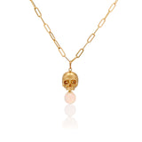 Necklaces 14k Gold & Opal Nehama Pendant A satin finished pendant inspired by a skull found in the Paris Catacombs. This hollow 14k gold skull features a gorgeous hand carved natural opal drop. This statement making pendant is named after Sarah Nehama, a