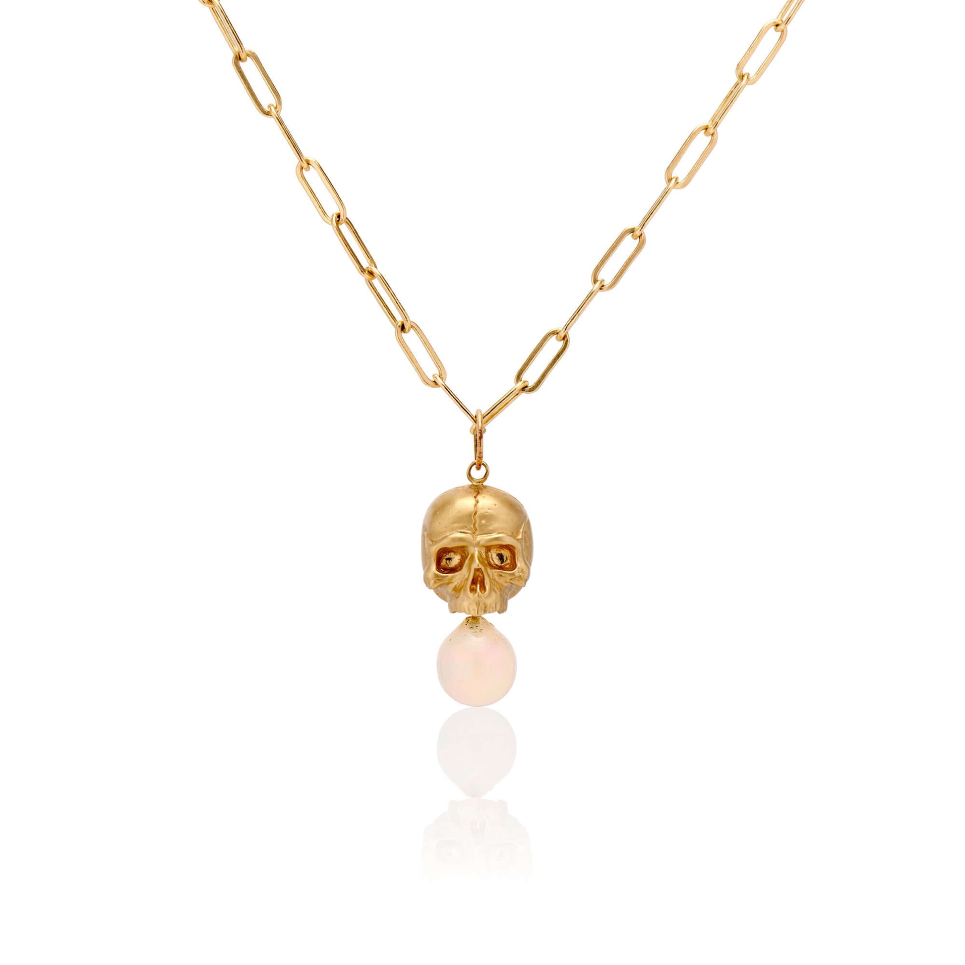 Necklaces 14k Gold & Opal Nehama Pendant A satin finished pendant inspired by a skull found in the Paris Catacombs. This hollow 14k gold skull features a gorgeous hand carved natural opal drop. This statement making pendant is named after Sarah Nehama, a