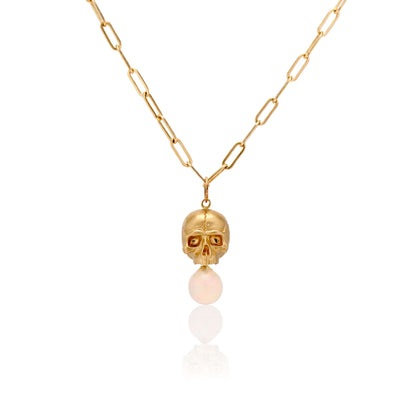 Necklaces 14k Gold & Opal Nehama Pendant A satin finished pendant inspired by a skull found in the Paris Catacombs. This hollow 14k gold skull features a gorgeous hand carved natural opal drop. This statement making pendant is named after Sarah Nehama, a