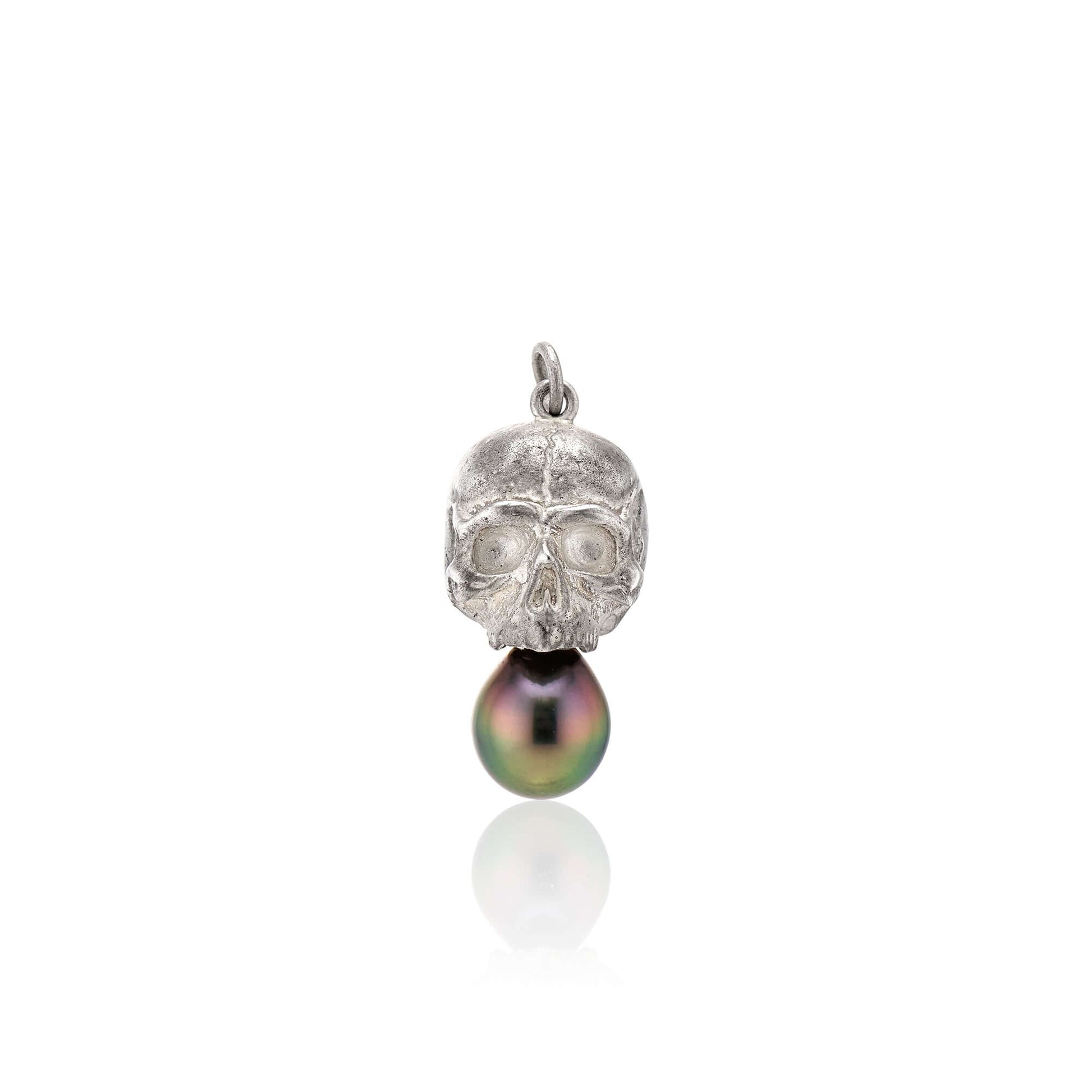 Nehama PendantA satin finished pendant inspired by a skull found in the Paris Catacombs. This hollow sterling silver skull features a hand picked black Tahitian pearl or golden south sea pearl. This statement making pendant is named after Sarah Nehama, a