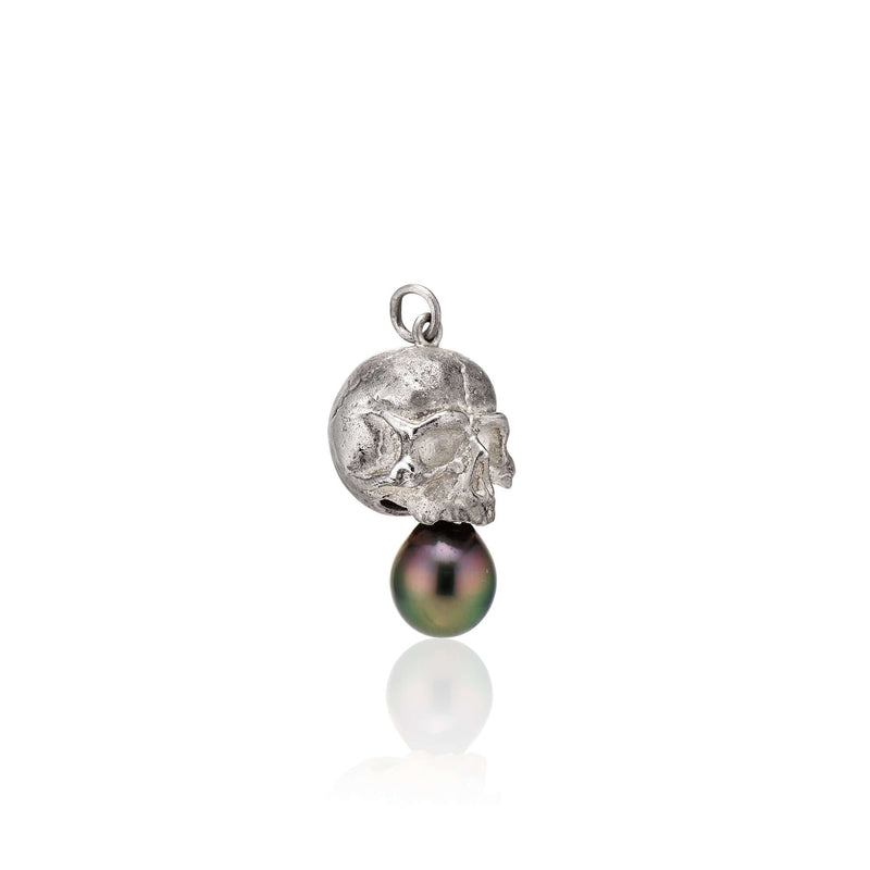 Nehama Pendant A satin finished pendant inspired by a skull found in the Paris Catacombs. This hollow sterling silver skull features a hand picked black Tahitian pearl or golden south sea pearl. This statement making pendant is named after Sarah Nehama, a