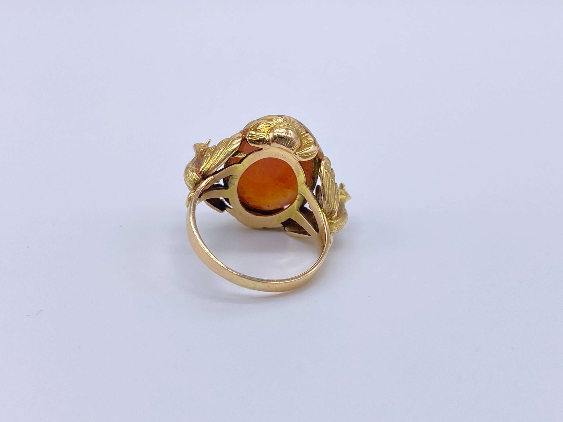 Antique Victorian Carnelian Peacock RingA gorgeous late Victorian ring with a substantial central carnelian stone. This ring has beautiful ruffled gold work around the stone. Two peacocks are suspended right above the shank. Condition: Normal antique wear