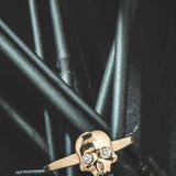 Diamond Ossification RingA little skull ring for every day wear with two shimmery diamonds in its eyes. We wanted to design a fun and simple skull ring that adds the perfect amount of goth and that could stack well with other rings. Our Jewelry is proudly