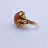 Antique Victorian Carnelian Peacock RingA gorgeous late Victorian ring with a substantial central carnelian stone. This ring has beautiful ruffled gold work around the stone. Two peacocks are suspended right above the shank. Condition: Normal antique wear