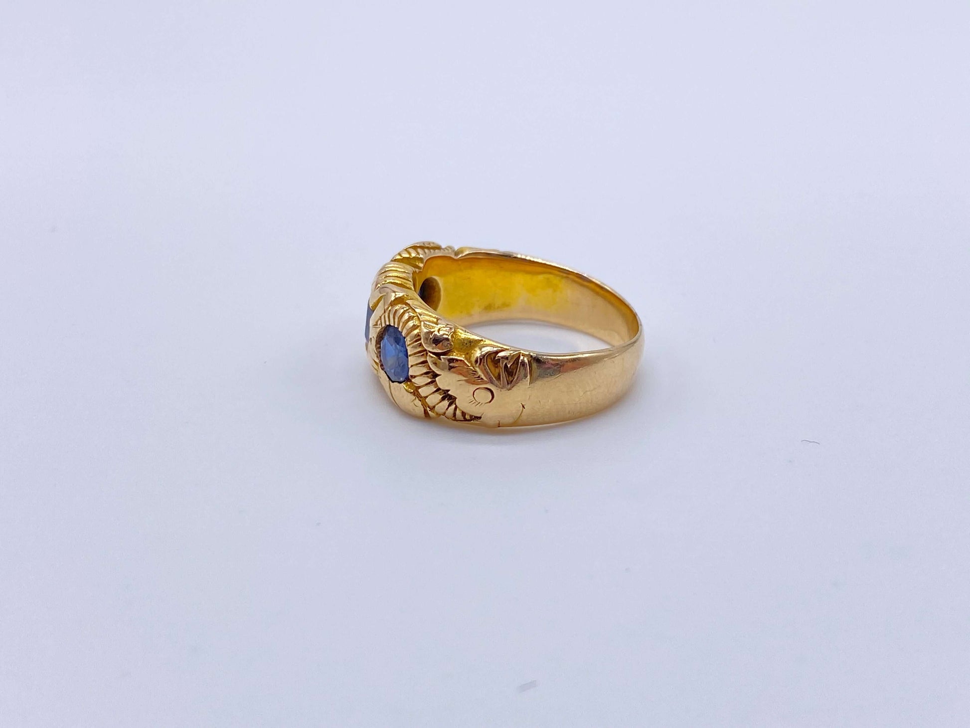 Hand Chased Victorian Ring with SapphiresA lovely c. 1890s Victorian ring hand chased with what appears to be a snake motif. 3 large sapphires are set into the ring. This ring has an amazing weight to it. Condition: Normal antique wear, very minimal scrat