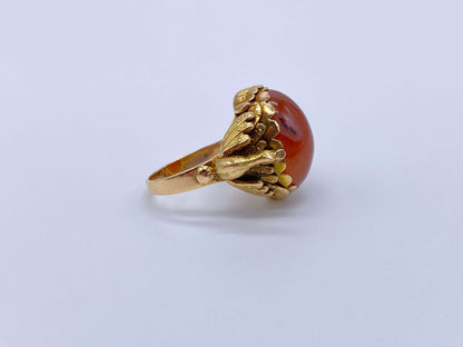 Antique Victorian Carnelian Peacock RingA gorgeous late Victorian ring with a substantial central carnelian stone. This ring has beautiful ruffled gold work around the stone. Two peacocks are suspended right above the shank. Condition: Normal antique wear