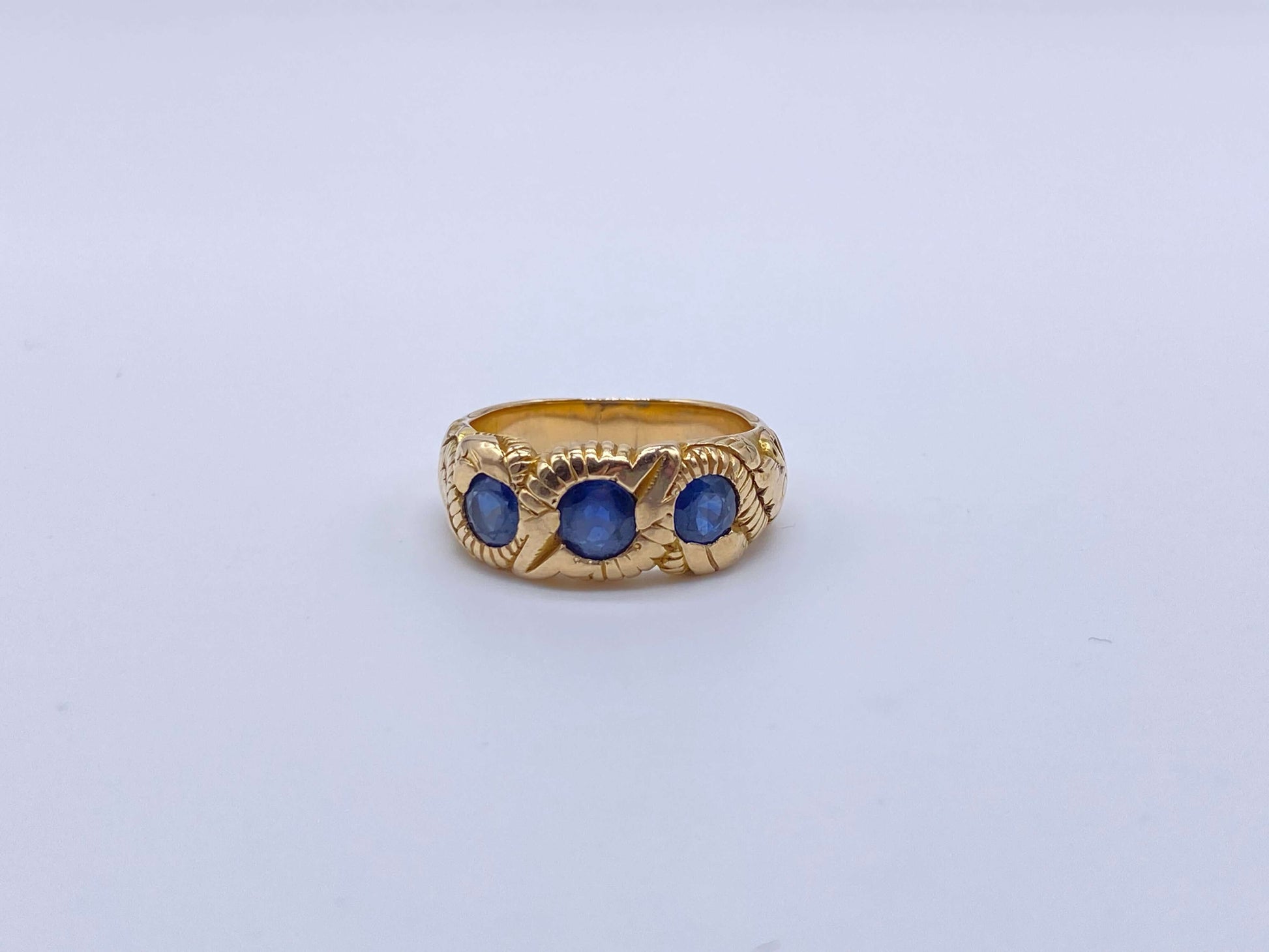 Hand Chased Victorian Ring with SapphiresA lovely c. 1890s Victorian ring hand chased with what appears to be a snake motif. 3 large sapphires are set into the ring. This ring has an amazing weight to it. Condition: Normal antique wear, very minimal scrat