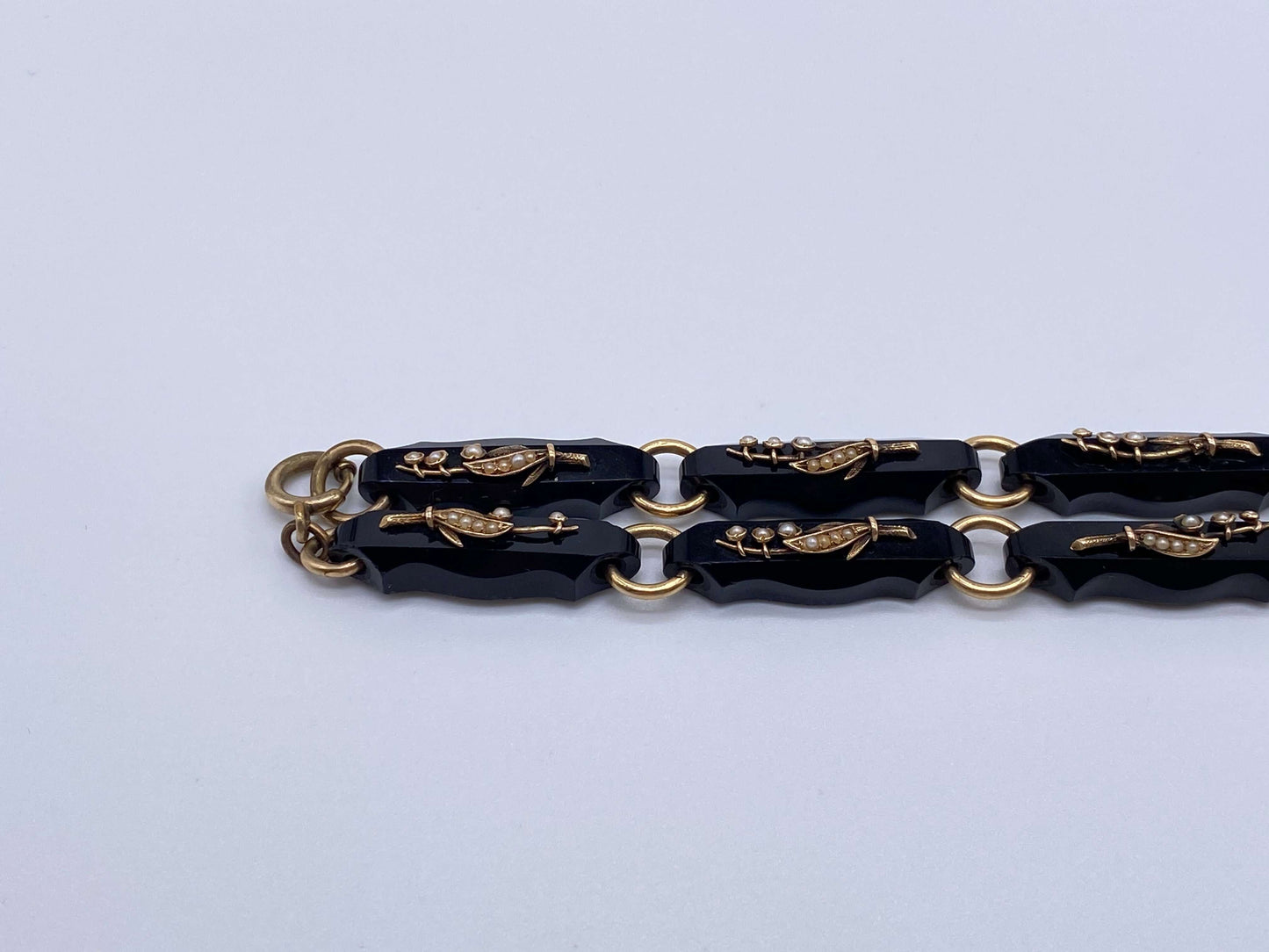 Black Onyx & Gold Lily of the Valley Bracelet SetThis bracelet set is gorgeous and versatile as it can also be worn as a necklace instead of two bracelets. Gorgeous pearls and gold are used to create Lily of the valley flowers on each individual black ony