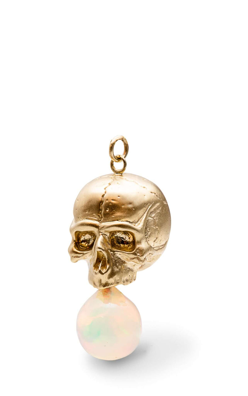 Necklaces 14k Gold & Opal Nehama Pendant A satin finished pendant inspired by a skull found in the Paris Catacombs. This hollow 14k gold skull features a gorgeous hand carved natural opal drop. This statement making pendant is named after Sarah Nehama, a