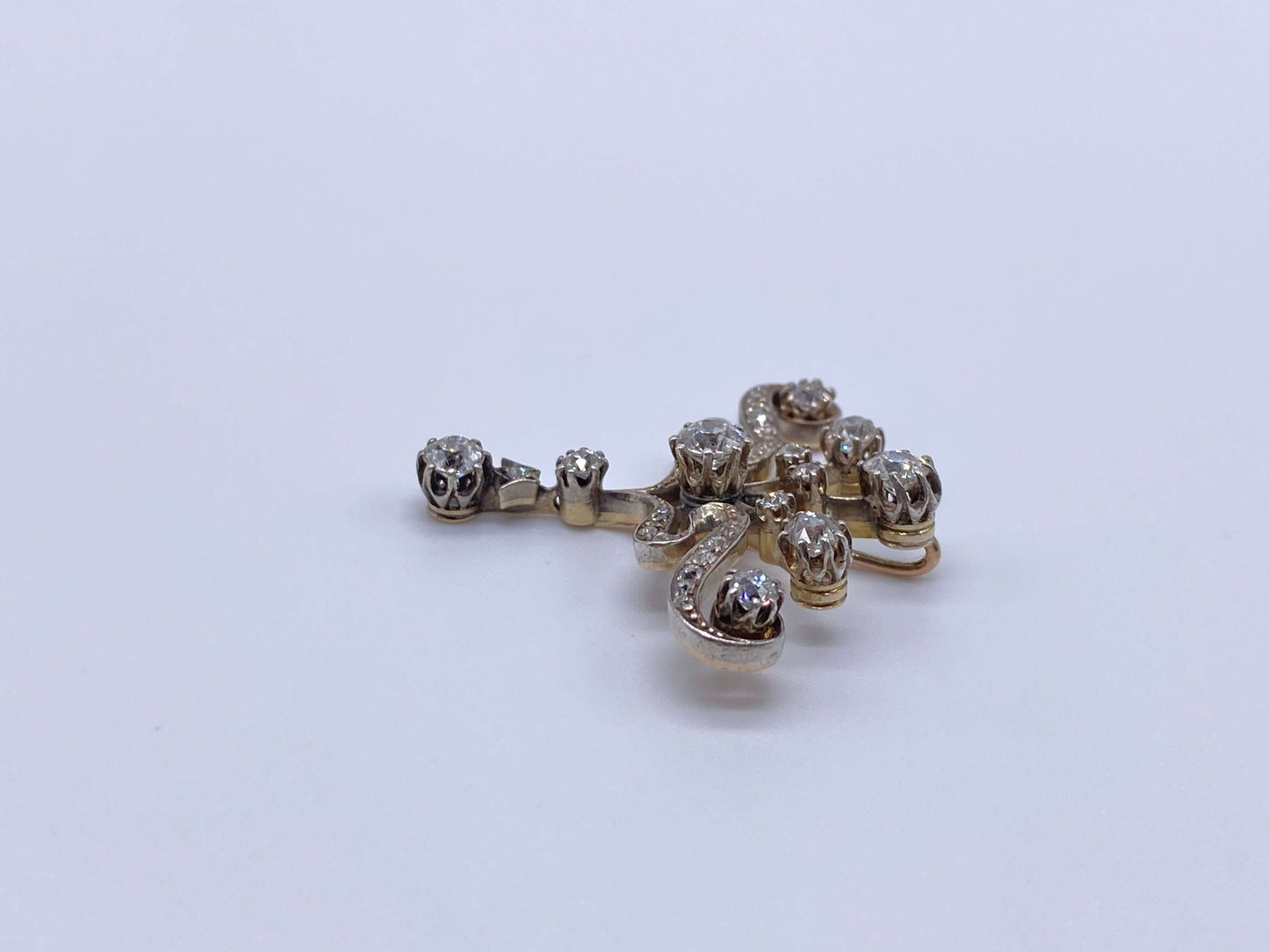 Edwardian Diamond PendantPictures alone cannot capture how beautiful this piece of jewelry is. Beautiful round cut diamonds set with prongs. The bottom diamond is a festoon drop that moves. Would look beautiful worn with a simple white gold chain. Conditi