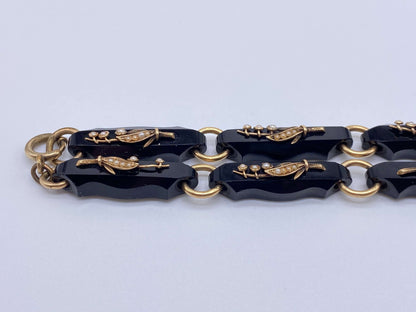 Black Onyx & Gold Lily of the Valley Bracelet SetThis bracelet set is gorgeous and versatile as it can also be worn as a necklace instead of two bracelets. Gorgeous pearls and gold are used to create Lily of the valley flowers on each individual black ony