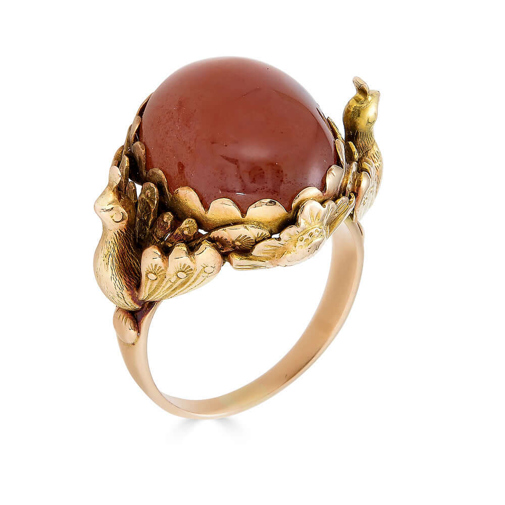 Antique Victorian Carnelian Peacock RingA gorgeous late Victorian ring with a substantial central carnelian stone. This ring has beautiful ruffled gold work around the stone. Two peacocks are suspended right above the shank. Condition: Normal antique wear