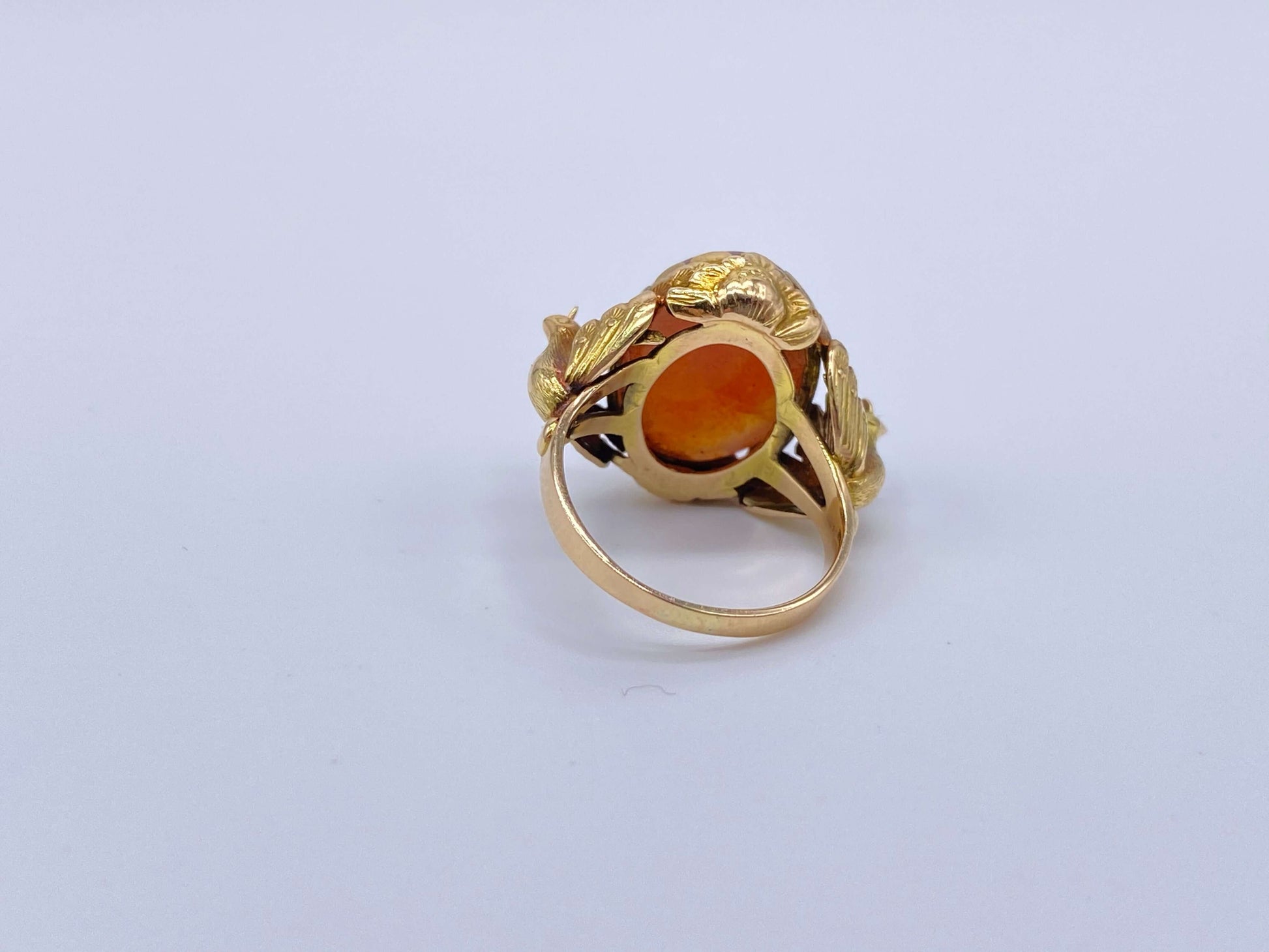 Antique Victorian Carnelian Peacock RingA gorgeous late Victorian ring with a substantial central carnelian stone. This ring has beautiful ruffled gold work around the stone. Two peacocks are suspended right above the shank. Condition: Normal antique wear