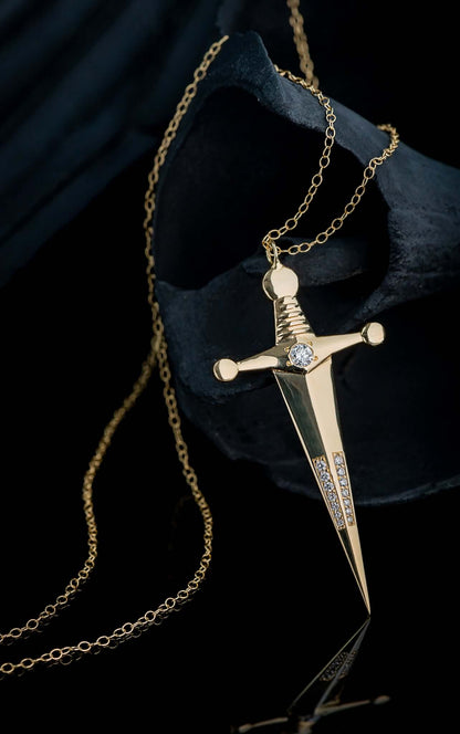 18k Gold Kelly Sword PendantA Luxe sword 18k Gold Kelly Sword Pendant for the individual wanting to make a powerful statement. Our Jewelry is proudly idealized, and produced in NYC.18k Gold Kelly Sword PendantA Luxe sword pendant for the individual wantin