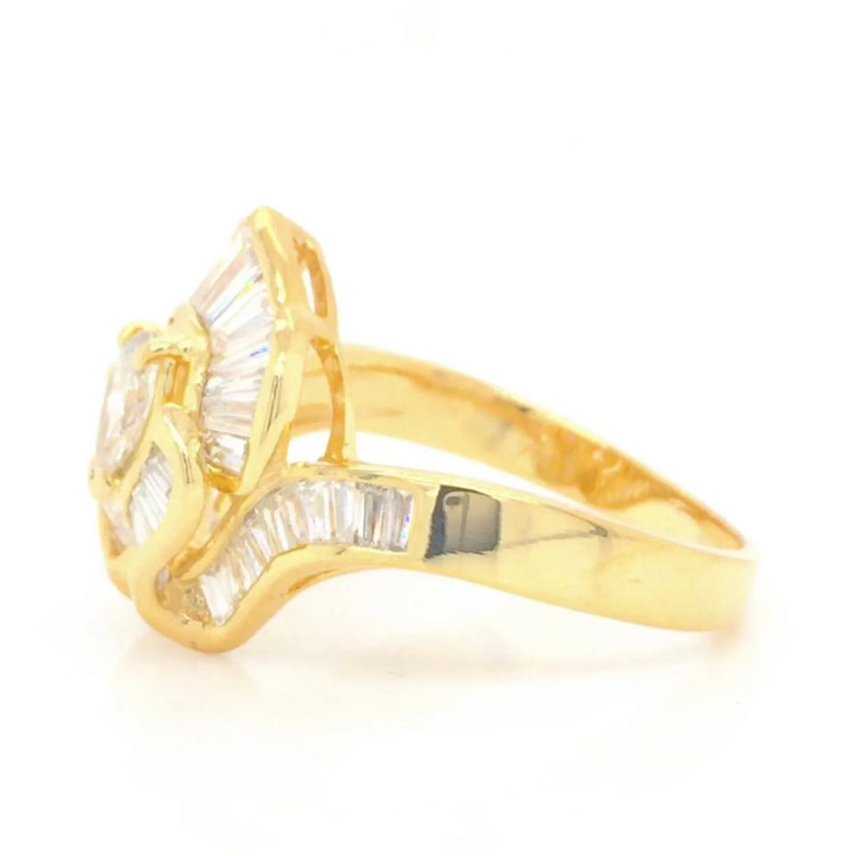 Vintage 18k Ballerina Ring with Pear-Shaped Diamond and Baguette MeleeA vintage diamond ring beautifully crafted in 18k gold with a central pear shaped diamond and a lovely arrangement of baguette diamonds that glisten in all sorts of light and will sure