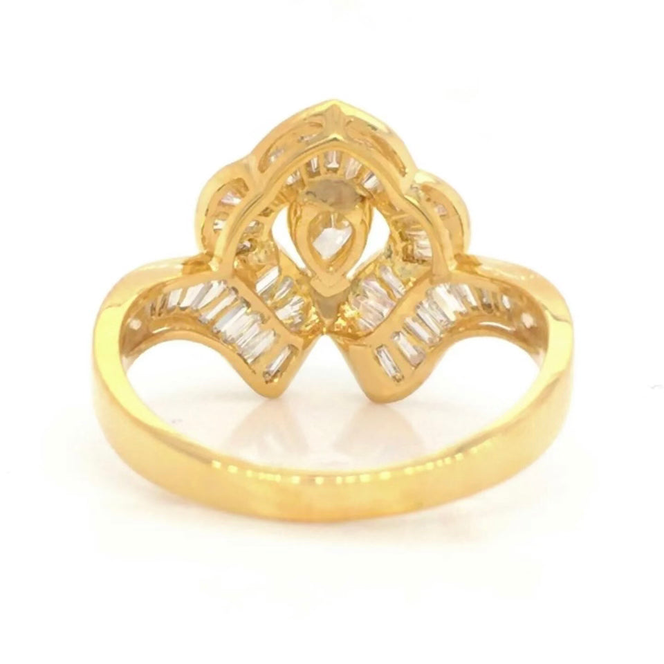 Vintage 18k Ballerina Ring with Pear-Shaped Diamond and Baguette MeleeA vintage diamond ring beautifully crafted in 18k gold with a central pear shaped diamond and a lovely arrangement of baguette diamonds that glisten in all sorts of light and will sure