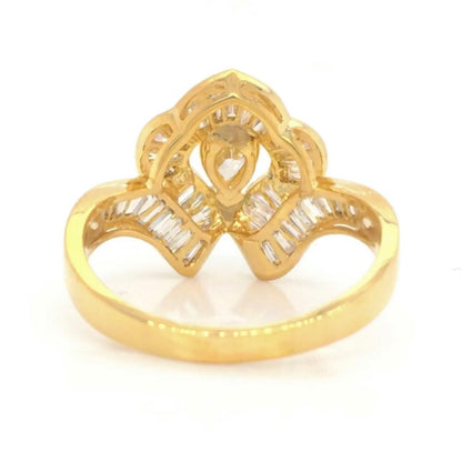 Vintage 18k Ballerina Ring with Pear-Shaped Diamond and Baguette MeleeA vintage diamond ring beautifully crafted in 18k gold with a central pear shaped diamond and a lovely arrangement of baguette diamonds that glisten in all sorts of light and will sure