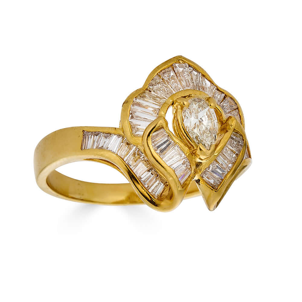 Vintage 18k Ballerina Ring with Pear-Shaped Diamond and Baguette MeleeA vintage diamond ring beautifully crafted in 18k gold with a central pear shaped diamond and a lovely arrangement of baguette diamonds that glisten in all sorts of light and will sure