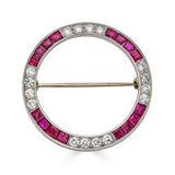 Antique Platinum Diamond and Ruby Circular BroochA bold brooch with rubies and diamonds set into platinum. There are so many possibilities; this can be used to pin a scarf together, worn on a hat, pinned to your favorite blouse. The possibilities are endl