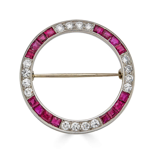 Antique Platinum Diamond and Ruby Circular BroochA bold brooch with rubies and diamonds set into platinum. There are so many possibilities; this can be used to pin a scarf together, worn on a hat, pinned to your favorite blouse. The possibilities are endl