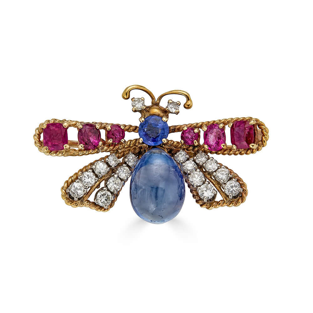 Vintage Ruby and Sapphire Drop Insect BroochThis gorgeous insect brooch features a gorgeous sapphire dangle, beautiful ruby and diamond wings and diamond eyes. You really can't go wrong with jewelry like this. It's simply amazing. A simple bale could be a