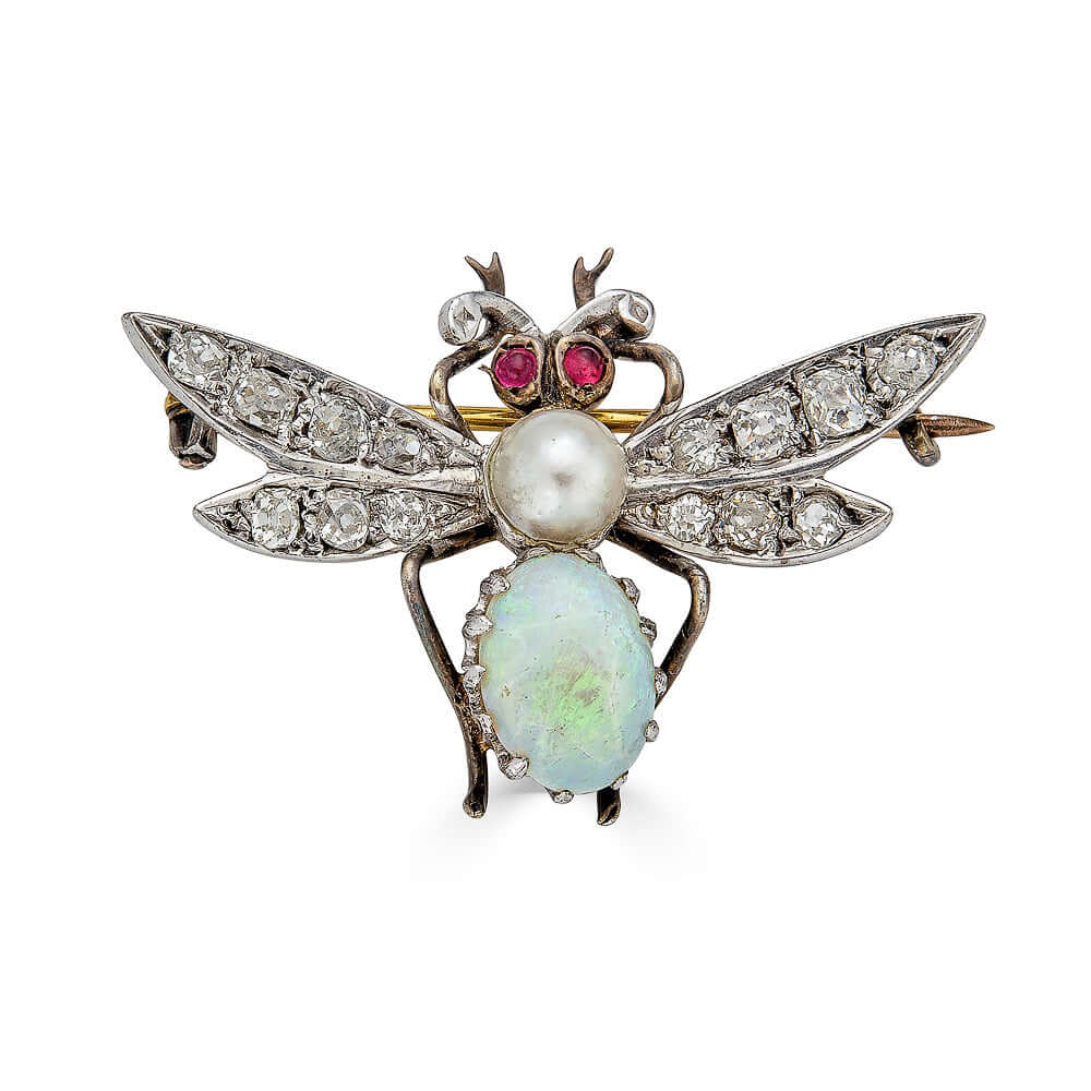 Antique Bee Brooch with GemstonesA lovely antique insect brooch featuring some of our favorite stones. The large wings have lovely diamonds set into them. The opal abdomen has a dreamy opal with various green hues in it. Ruby cabochon eyes captivate and a