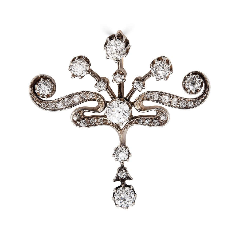 Edwardian Diamond PendantPictures alone cannot capture how beautiful this piece of jewelry is. Beautiful round cut diamonds set with prongs. The bottom diamond is a festoon drop that moves. Would look beautiful worn with a simple white gold chain. Conditi